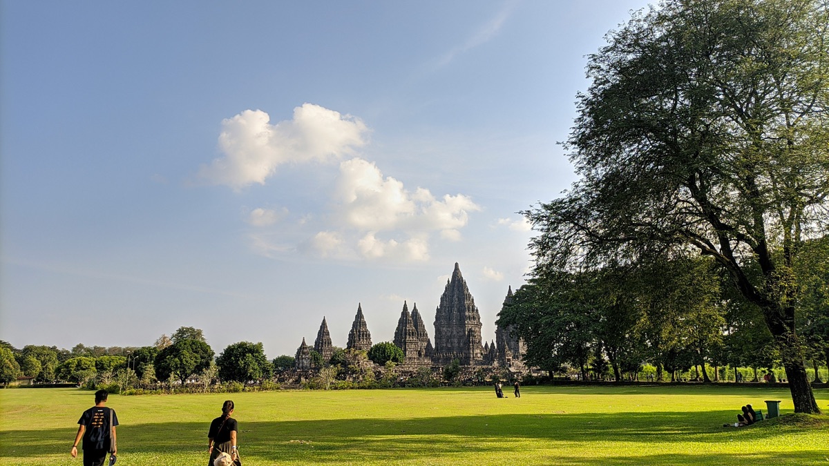 Prambanan temples viewed across the green lawns of the archaeological park